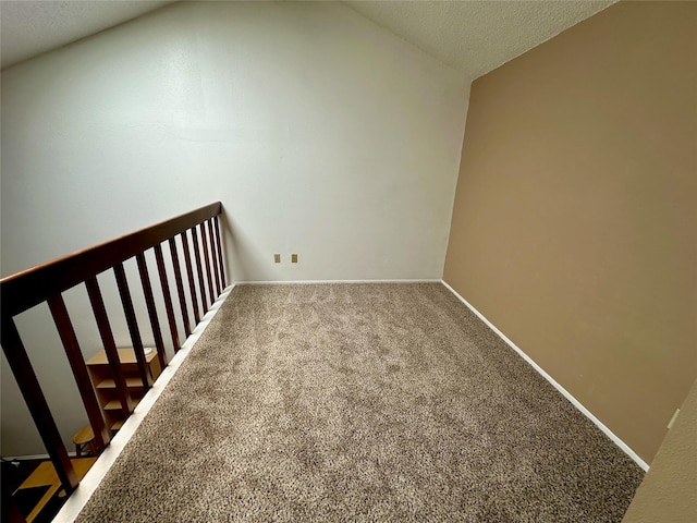 2611 Grants Lake Blvd Unit 237, Sugar Land, TX 77479 - bonus room featuring carpet, a textured ceiling, baseboards, and lofted ceiling