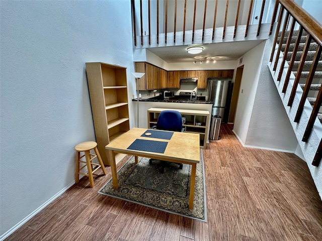 2611 Grants Lake Blvd Unit 237, Sugar Land, TX 77479 - dining space featuring a textured wall, baseboards, wood finished floors, stairway, and a desk