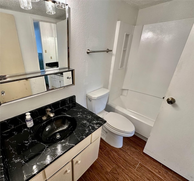 2611 Grants Lake Blvd Unit 237, Sugar Land, TX 77479 - full bathroom featuring wood finished floors, vanity, toilet, a textured ceiling, and shower / bathtub combination