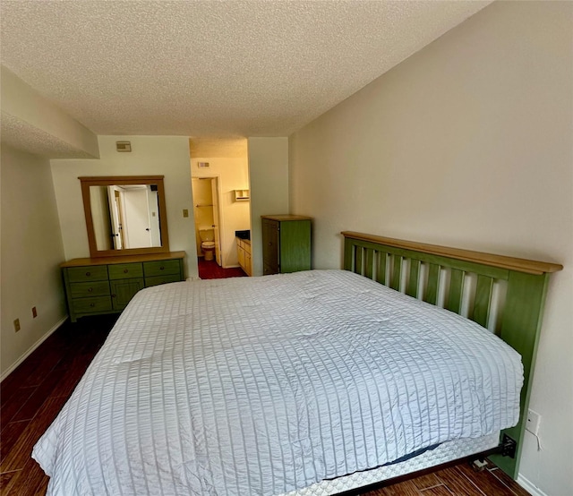 2611 Grants Lake Blvd Unit 237, Sugar Land, TX 77479 - bedroom with a textured ceiling, wood finished floors, and baseboards