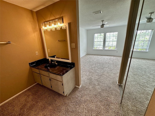 2611 Grants Lake Blvd Unit 237, Sugar Land, TX 77479 - bathroom featuring a textured ceiling, baseboards, a ceiling fan, and vanity