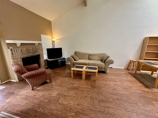 2611 Grants Lake Blvd Unit 237, Sugar Land, TX 77479 - living room featuring high vaulted ceiling, baseboards, a fireplace, and wood finished floors