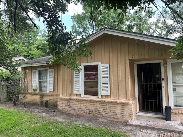 7722 Claiborne St, Houston, TX 77016 - view of exterior entry with brick siding and board and batten siding