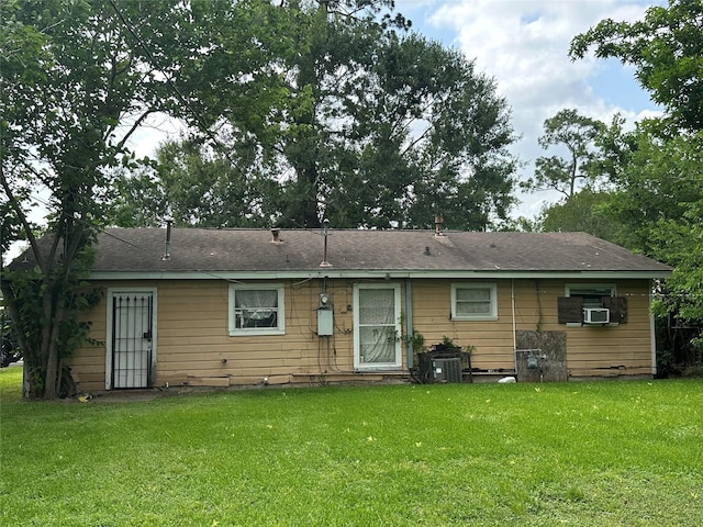 7722 Claiborne St, Houston, TX 77016 - rear view of house featuring a yard, cooling unit, and central AC