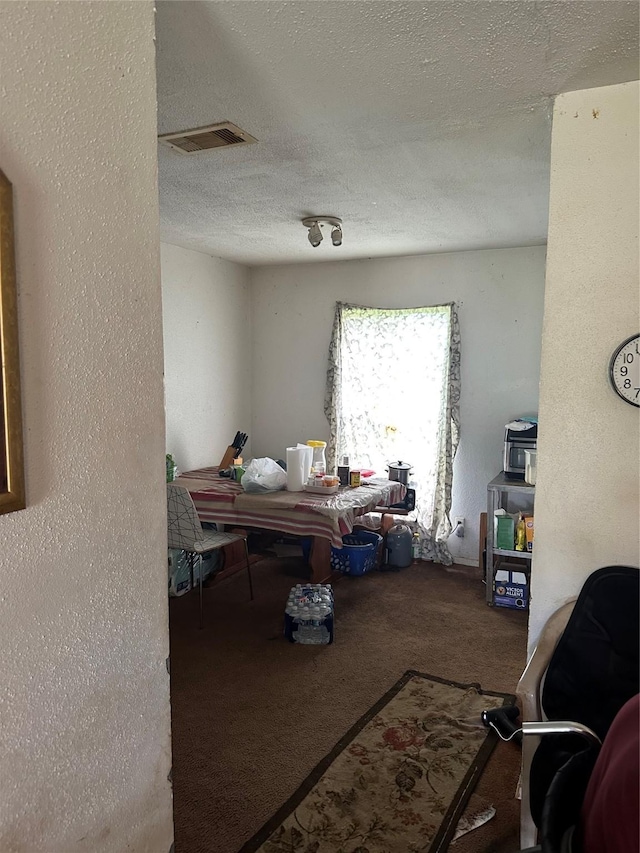 7722 Claiborne St, Houston, TX 77016 - carpeted dining room with a textured ceiling