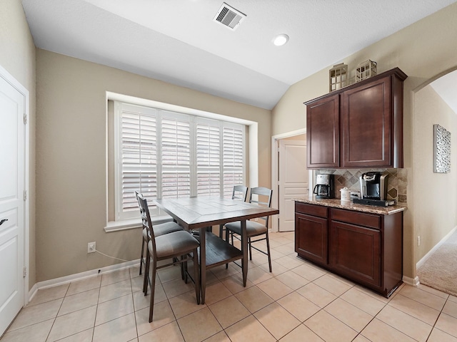 29954 Spring Creek Ln, Brookshire, TX 77423 - dining area with arched walkways, lofted ceiling, baseboards, and light tile patterned floors