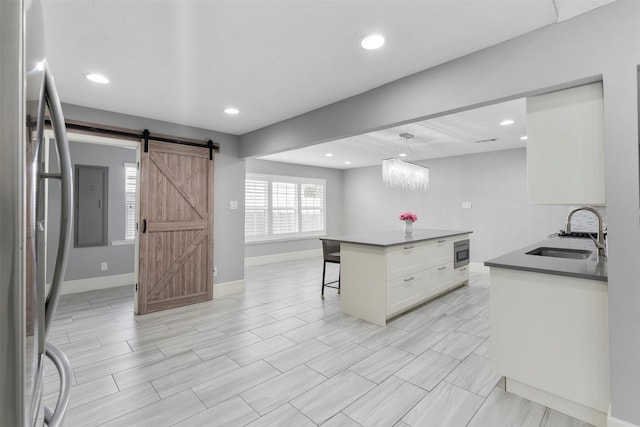 7727 Barberton Dr, Houston, TX 77036 - kitchen with a sink, appliances with stainless steel finishes, a kitchen bar, baseboards, and recessed lighting