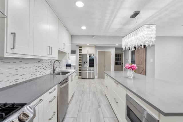 7727 Barberton Dr, Houston, TX 77036 - kitchen featuring stainless steel appliances, a sink, white cabinets, decorative backsplash, and recessed lighting