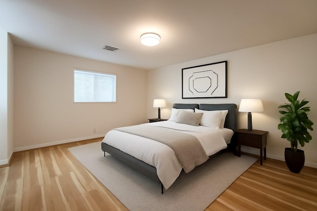 bedroom featuring light wood-style flooring and baseboards