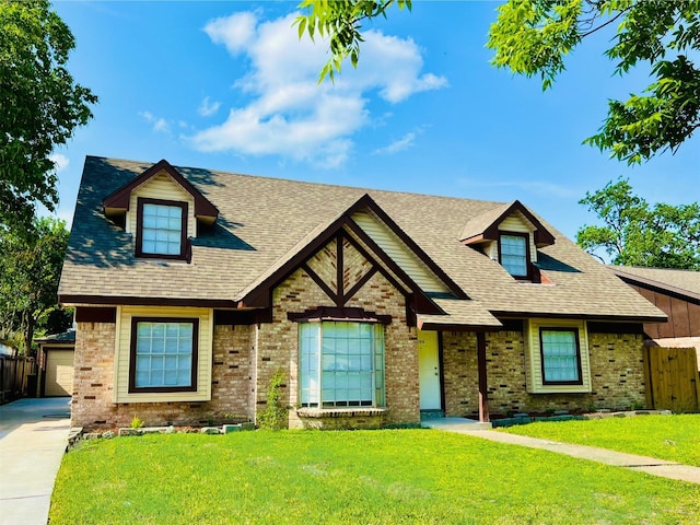 view of front facade with brick siding and a shingled roof
