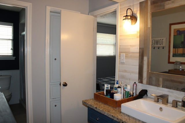 11615 Primwood Dr, Houston, TX 77070 - bathroom with backsplash, toilet, vanity, and wood walls