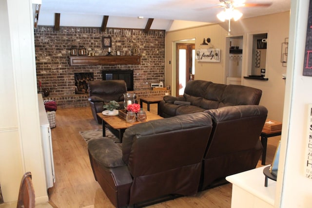 11615 Primwood Dr, Houston, TX 77070 - living room with light wood finished floors, ceiling fan, a brick fireplace, and brick wall