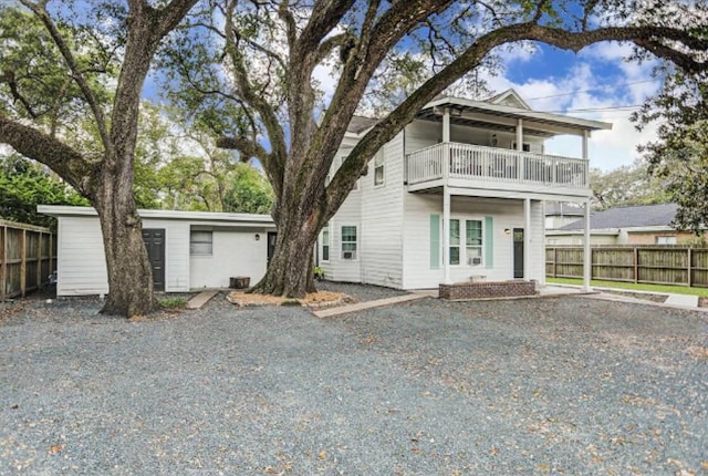 511 W Cleveland St, Alvin, TX 77511 - view of front of property with a balcony, fence, and driveway