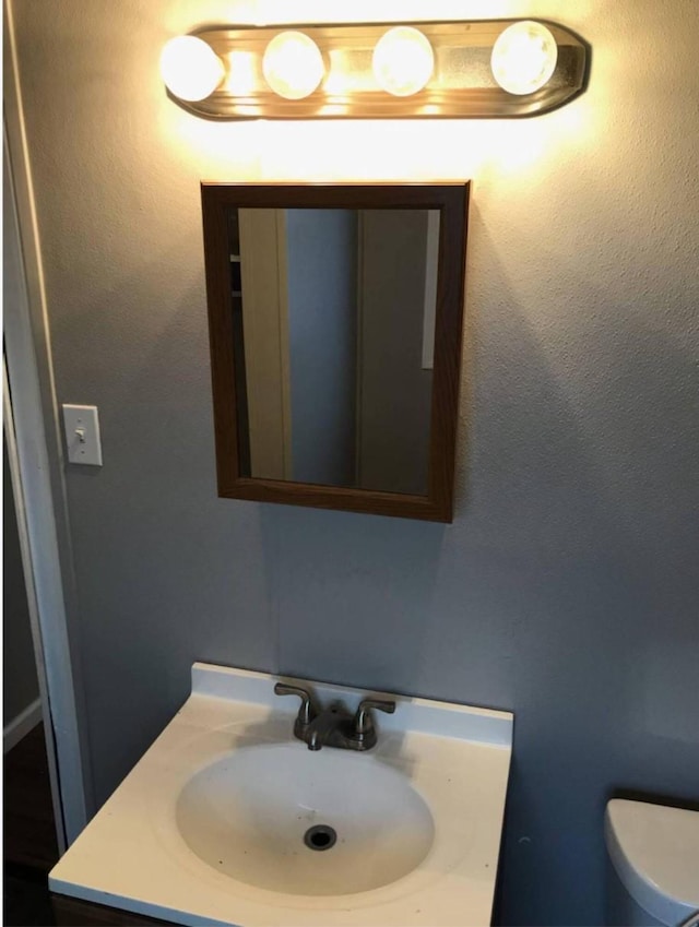 511 W Cleveland St, Alvin, TX 77511 - half bathroom featuring vanity and toilet