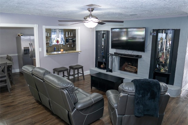 6238 Westwick Dr, Houston, TX 77072 - living area featuring ceiling fan, a textured ceiling, wood finished floors, a high end fireplace, and baseboards