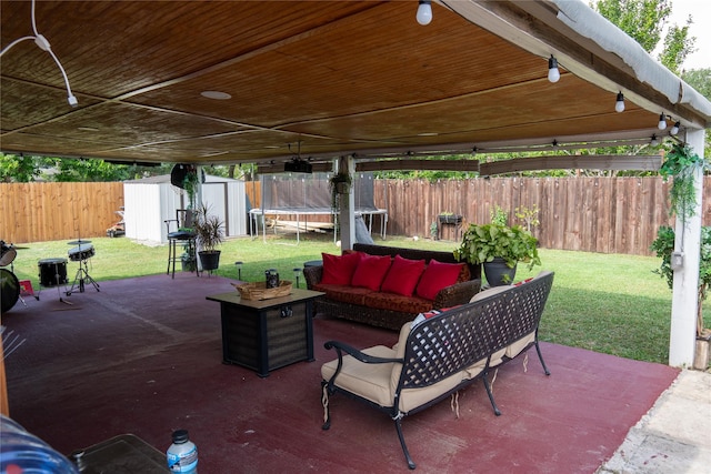 6238 Westwick Dr, Houston, TX 77072 - view of patio with a trampoline, a storage unit, an outdoor structure, and an outdoor hangout area