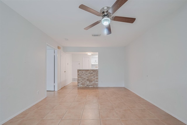 811 Wax Myrtle Ln Unit A, Houston, TX 77079 - empty room with a ceiling fan, light tile patterned floors, and baseboards