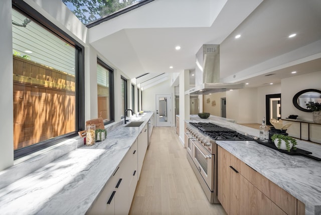 2135 Quenby St, Houston, TX 77005 - kitchen with modern cabinets, high end range, light wood finished floors, island range hood, and plenty of natural light
