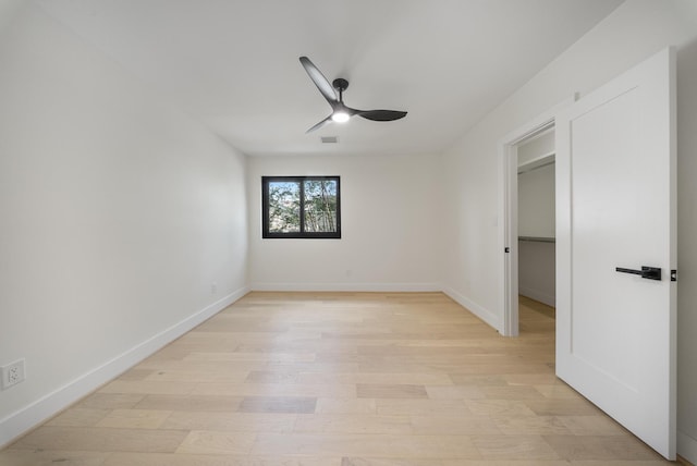 2135 Quenby St, Houston, TX 77005 - unfurnished bedroom with light wood finished floors, baseboards, and a walk in closet