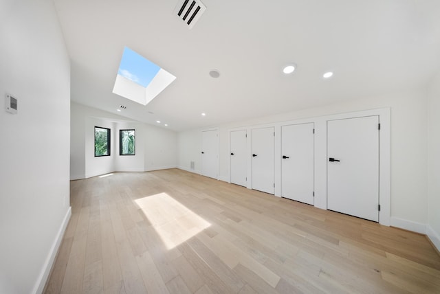 2135 Quenby St, Houston, TX 77005 - unfurnished room with a skylight, light wood-style floors, vaulted ceiling, baseboards, and recessed lighting