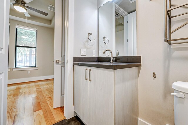 2401 Crawford St Unit C2B, Houston, TX 77004 - half bath featuring a ceiling fan, wood finished floors, vanity, toilet, and baseboards