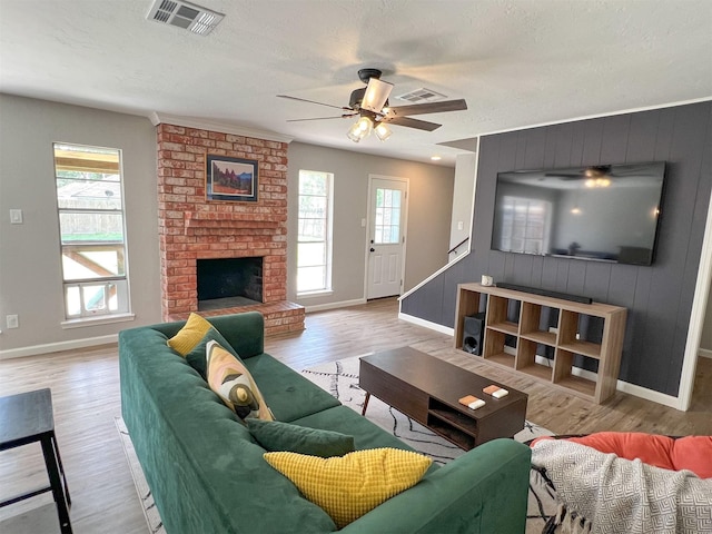 6019 Lawn Ln, Houston, TX 77088 - living area with ceiling fan, healthy amount of natural light, wood finished floors, and wood walls
