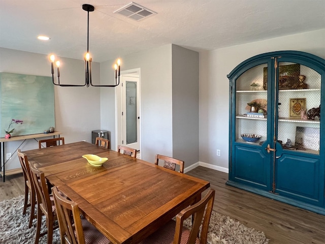 6019 Lawn Ln, Houston, TX 77088 - dining room featuring dark wood-style floors and a chandelier