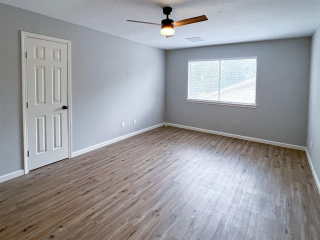 6019 Lawn Ln, Houston, TX 77088 - empty room with wood finished floors and a ceiling fan