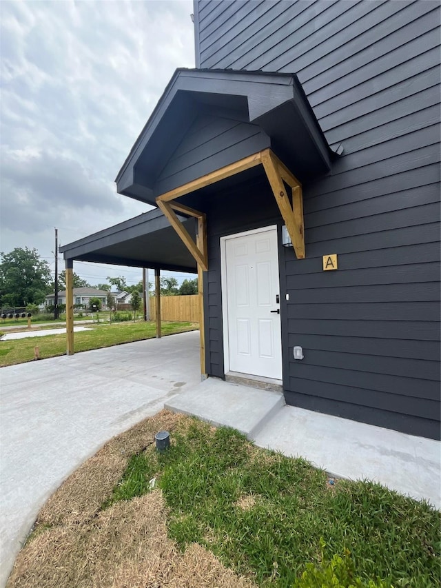 8605 Wileyvale Rd, Houston, TX 77016 - view of exterior entry featuring a carport and concrete driveway