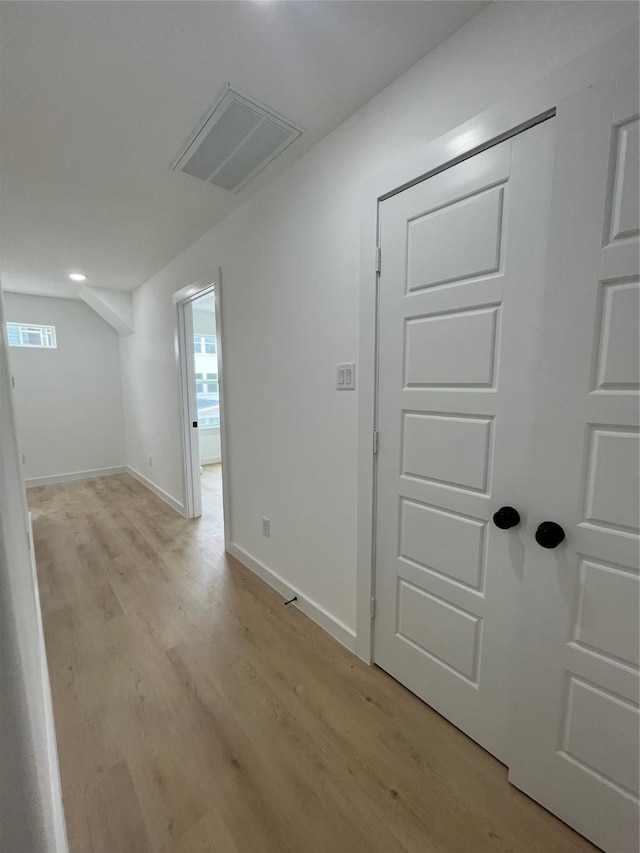 8605 Wileyvale Rd, Houston, TX 77016 - hallway featuring light wood finished floors, plenty of natural light, and baseboards