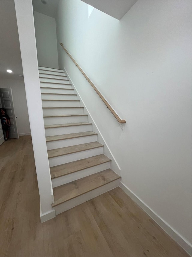 8605 Wileyvale Rd, Houston, TX 77016 - staircase with wood finished floors, baseboards, and recessed lighting