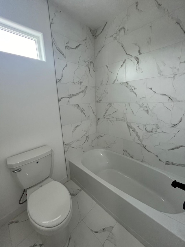 8605 Wileyvale Rd, Houston, TX 77016 - full bath featuring marble look tile flooring, toilet, and baseboards