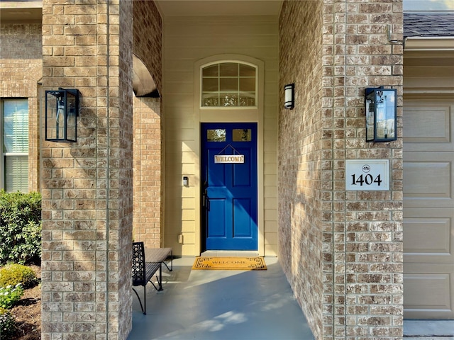 1404 Laguna Cv, Hutto, TX 78634 - doorway to property featuring a shingled roof and brick siding