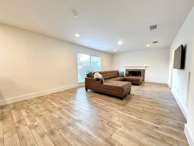1404 Laguna Cv, Hutto, TX 78634 - living area with light wood-style flooring, a stone fireplace, baseboards, and recessed lighting