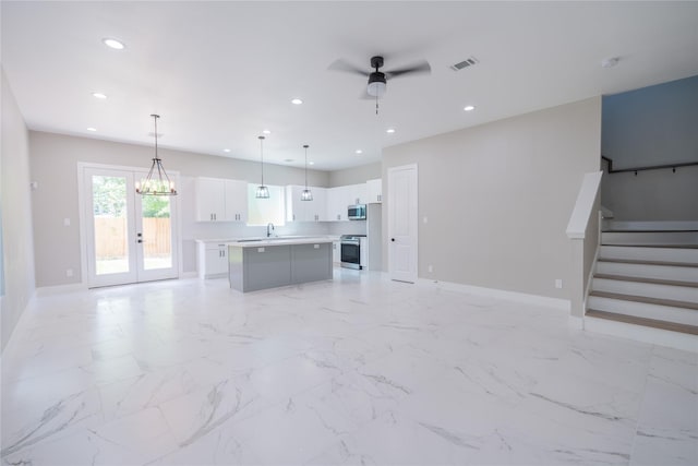 6535 Cohn St, Houston, TX 77091 - unfurnished living room with a ceiling fan, baseboards, recessed lighting, stairway, and a sink