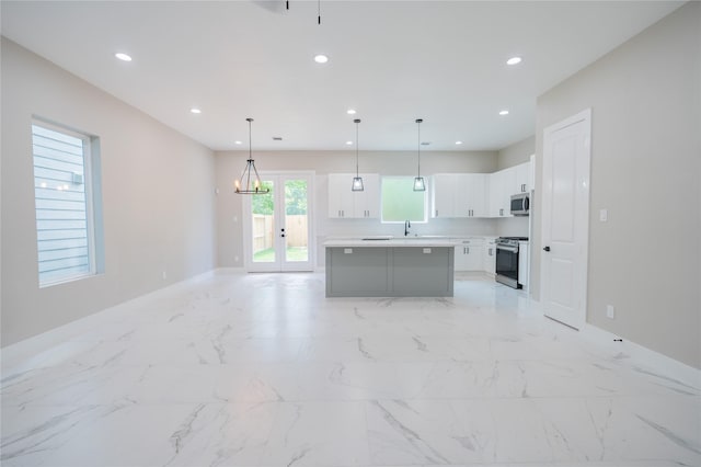 6535 Cohn St, Houston, TX 77091 - kitchen featuring stainless steel appliances, baseboards, white cabinetry, light countertops, and recessed lighting