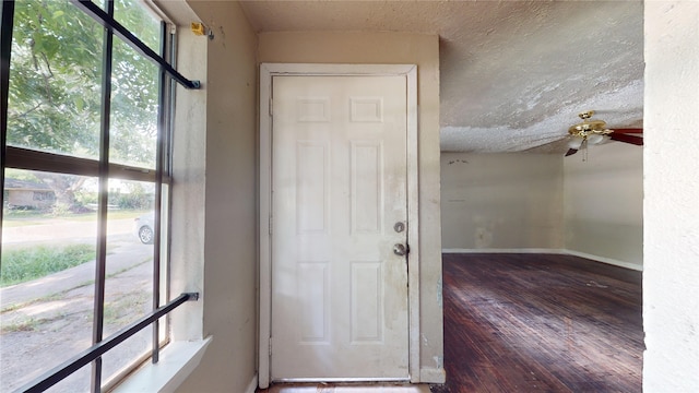 4618 Mallow St, Houston, TX 77051 - foyer featuring hardwood / wood-style floors, a ceiling fan, a textured ceiling, and baseboards