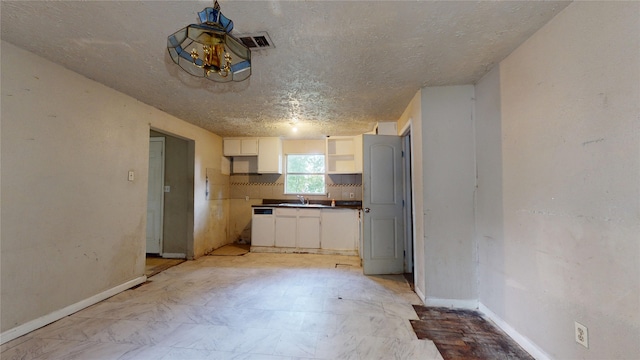 4618 Mallow St, Houston, TX 77051 - kitchen with white cabinetry, open shelves, baseboards, a textured ceiling, and dark countertops