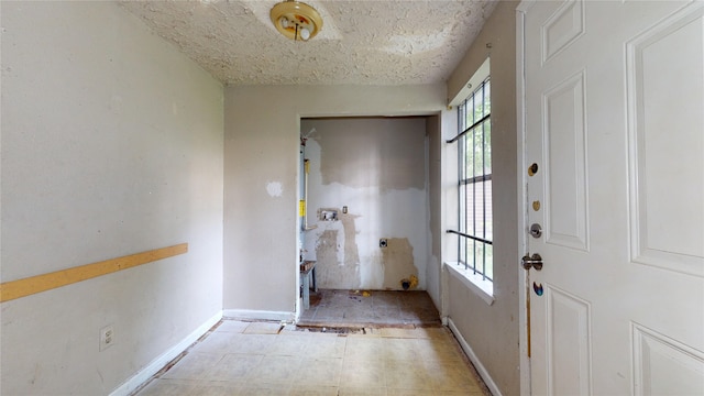 4618 Mallow St, Houston, TX 77051 - doorway with baseboards and a textured ceiling