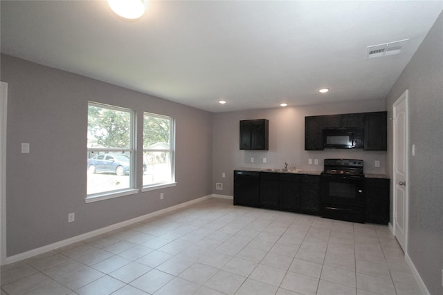 16946 W Lynbrook, Montgomery, TX 77316 - kitchen with black appliances, a sink, light tile patterned flooring, light countertops, and dark cabinets