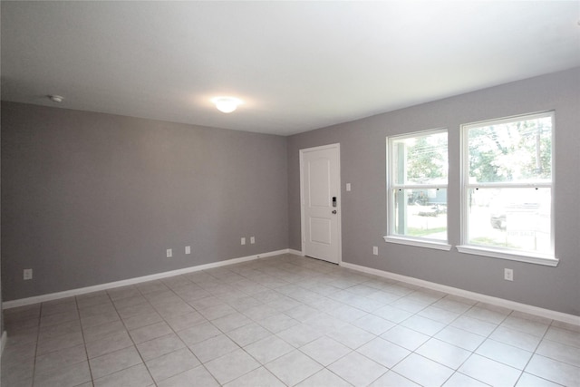 16946 W Lynbrook, Montgomery, TX 77316 - spare room with baseboards, light tile patterned floors, and a smoke detector
