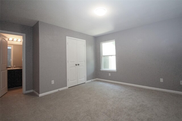 16946 W Lynbrook, Montgomery, TX 77316 - unfurnished bedroom with carpet, baseboards, a closet, and ensuite bathroom