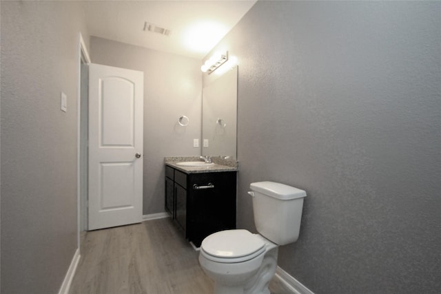16946 W Lynbrook, Montgomery, TX 77316 - half bath with wood finished floors, vanity, toilet, and baseboards