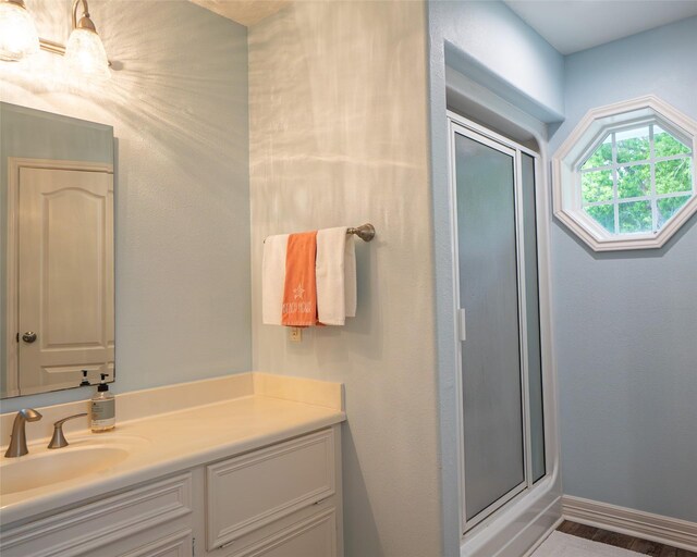 383 County Road 296, Sargent, TX 77414 - full bathroom with a shower stall, vanity, baseboards, and wood finished floors