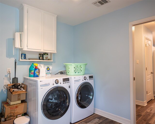 383 County Road 296, Sargent, TX 77414 - laundry room with wood finished floors, washer and dryer, cabinet space, and baseboards