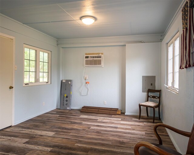 383 County Road 296, Sargent, TX 77414 - unfurnished room with an AC wall unit, electric panel, and dark wood-type flooring