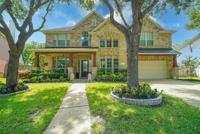 5515 E Terrace Gable Cir, Katy, TX 77494 - view of front of property with a garage, a standing seam roof, a front lawn, driveway, and stone siding