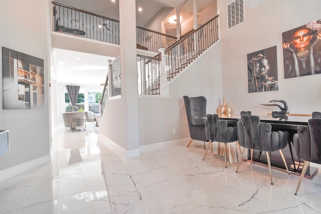 5515 E Terrace Gable Cir, Katy, TX 77494 - dining room featuring a high ceiling, marble tiled floors, baseboards, stairway, and recessed lighting