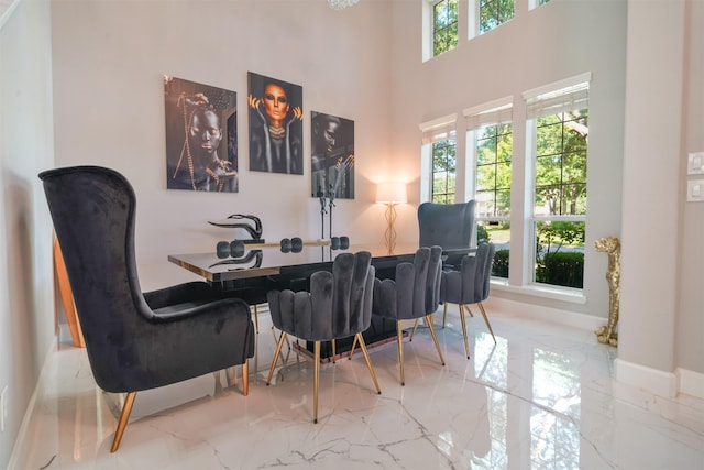 5515 E Terrace Gable Cir, Katy, TX 77494 - dining room with marble tiled flooring, baseboards, and a towering ceiling