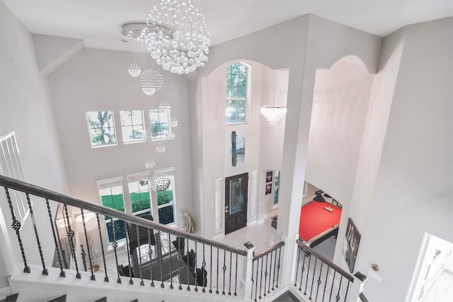5515 E Terrace Gable Cir, Katy, TX 77494 - stairway with a towering ceiling and a chandelier